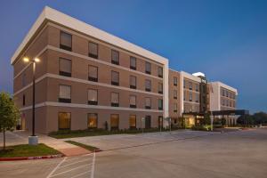 a large building with a parking lot in front of it at Home2 Suites By Hilton Lewisville Dallas in Lewisville