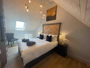 a bedroom with a bed with two bags on it at The Carriage House in Salisbury