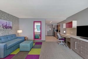 a living room with a couch and a dining room at Home2 Suites By Hilton Buckeye Phoenix in Buckeye