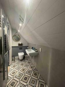 a bathroom with a white toilet and a sink at The Carriage House in Salisbury