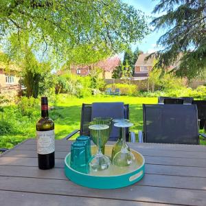 a bottle of wine and glasses on a table at Dunham House in Newark-on-Trent