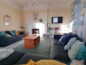 a living room with a couch and a table at Dunham House in Dunham