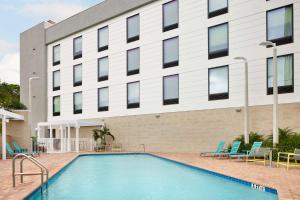 a swimming pool in front of a building at Home2 Suites By Hilton Stuart in Stuart