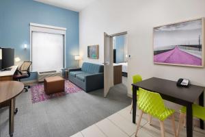 a living room with a couch and a table at Home2 Suites By Hilton Stuart in Stuart