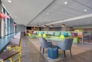 a lobby with colorful furniture and tables and chairs at Home2 Suites By Hilton Tracy, Ca in Tracy