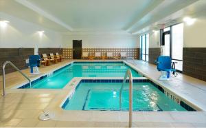 a swimming pool with blue water in a building at Hampton Inn Colorado Springs I-25 Central in Colorado Springs