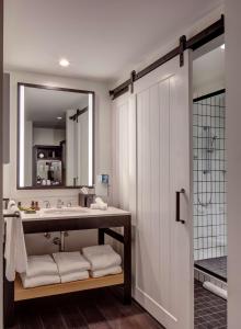 y baño con lavabo y espejo. en Canopy By Hilton Baltimore Harbor Point - Newly Built en Baltimore