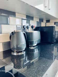 a kitchen with a counter with a coffee maker at Deluxe 2 Bedroom Apartment in Sheffield