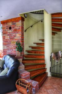 a set of stairs in a living room with a couch at The Mountain Cottage - Hegyi kuckó in Bükkzsérc