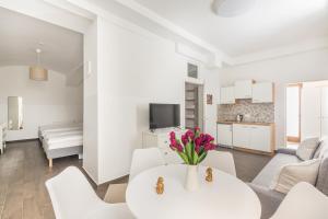 a white living room with a white table and white chairs at Cozy Heaven in the lovely 2nd district of Vienna in Vienna