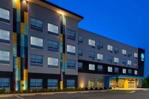 a building with a lit up facade at night at Tru By Hilton Spartanburg in Spartanburg