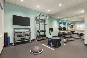 a gym with a large room with a flat screen tv at Tru By Hilton Ringgold, Ga in Ringgold