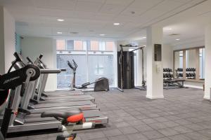 a gym with treadmills and machines in a room at Hampton By Hilton Manchester Northern Quarter in Manchester