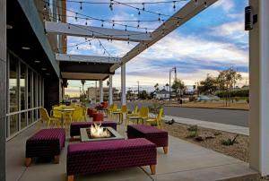 a patio with tables and chairs and a fire pit at Home2 Suites By Hilton Yuma Pivot Point in Yuma