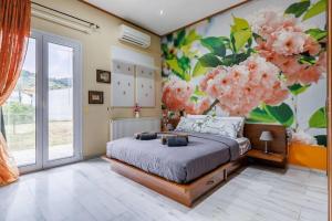 a bedroom with a bed with a flower mural at Unique Filoxenia! in Skopelos Town