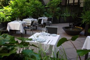 a patio with tables with white tablecloths at Atocha Hotel Madrid, Tapestry Collection by Hilton in Madrid