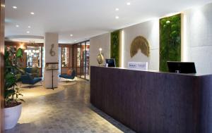 a lobby of a hotel with a reception desk at Atocha Hotel Madrid, Tapestry Collection by Hilton in Madrid