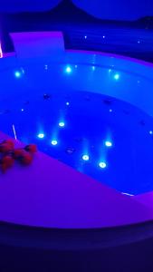 a pool of water with lights in a room at L'angolo dei sogni in Acitrezza