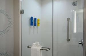 a bathroom with a shower with a glass door at Tru By Hilton Columbus Airport in Columbus