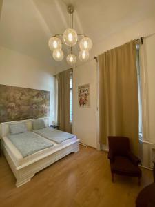 um quarto com uma cama e um lustre em Pension Wienderland em Viena