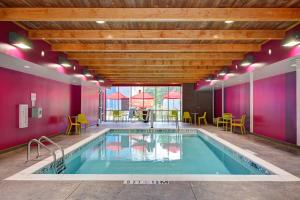 a swimming pool with purple walls and a wooden ceiling at Home2 Suites By Hilton Fort Mill, Sc in Fort Mill