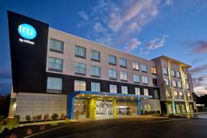 a lit up building with a hotel at Tru By Hilton Concord, Nh in Concord