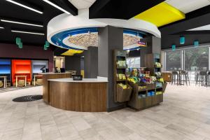 a lobby of a store with a counter and chairs at Tru By Hilton Dallas Market Center in Dallas