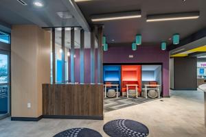 a lobby with chairs and tables in a building at Tru By Hilton Dallas Market Center in Dallas