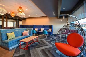 a lobby with a couch and a table and chairs at Tru By Hilton Concord, Nh in Concord