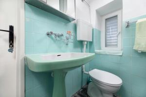 a blue bathroom with a sink and a toilet at Apartment Dunato in Polje +11 photos