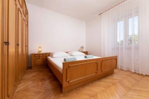 a bedroom with a large bed and a window at Apartment Dunato in Polje