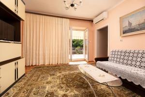a living room with a couch and a table at Apartment Dunato in Polje