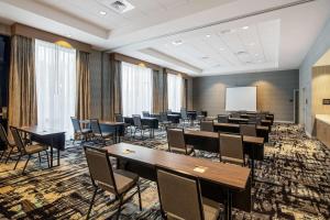 a conference room with tables and chairs and a whiteboard at Hampton Inn & Suites Raleigh Midtown, NC in Raleigh +35 photos