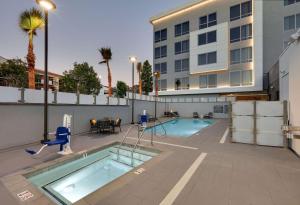 a swimming pool in front of a building at Homewood Suites By Hilton Irvine Spectrum Lake Forest in Lake Forest