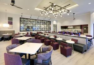 a restaurant with tables and chairs and a bar at Homewood Suites By Hilton Irvine Spectrum Lake Forest in Lake Forest