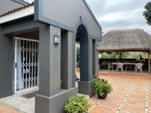 a house with a patio and a gazebo at Nonna's Cottage in Durban