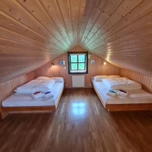 two beds in a small room with a small window at Minniborgir Cabins in Minni-Borg