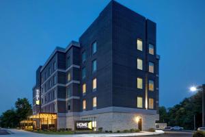 a black building with a sign on it at Home2 Suites By Hilton Carmel Indianapolis in Carmel