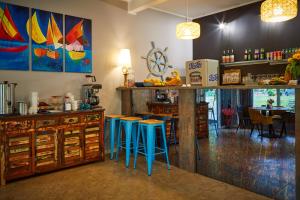 a bar with blue stools in a room at Ośrodek Wypoczynkowy Nad Zatoką in Koronowo