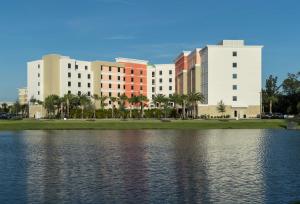 a group of buildings next to a body of water at Home2 Suites By Hilton Cape Canaveral Cruise Port in Cape Canaveral