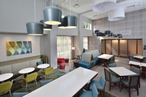 a dining room with tables and chairs and lights at Hampton Inn & Suites Charlotte North I 485 in Charlotte
