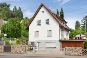 a white house with a brown roof at Ferienwohnung Kramer in Überlingen