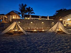 a couple of tents on the beach at night at 4U Resort Samui in Lamai