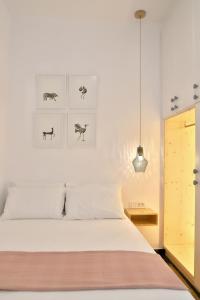 a bedroom with a bed and a pendant light at Down Town Sitia i in Sitia