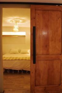 a door leading into a bedroom with a bed at cozy studio in cite ennasr 1 in Ariana