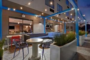 a patio with a table and chairs and a building at Tru By Hilton Fort Mill, Sc in Fort Mill