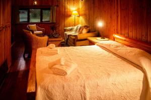 a bedroom with a bed with two towels on it at Paso de los Troperos in La Junta