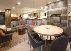 a living room with a table and chairs and a couch at Doubletree By Hilton Chico, Ca in Chico