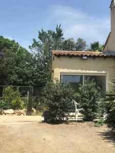 a bench sitting in front of a house at studio centre ville avec jardin in Sainte-Maxime