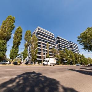 a van parked in front of a large building at Aparthotel Mirage Sunset - zona Hotel Rex in Mamaia